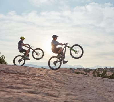 Rear bike racks provide added storage capacity for carrying cargo, groceries, or gear on biking. They help distribute weight evenly for better balance and stability while riding a bike.